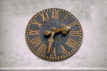 Fototapeta na wymiar Ancient wall clock with Roman numerals