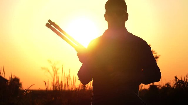 man racks his shotgun sunset 4k