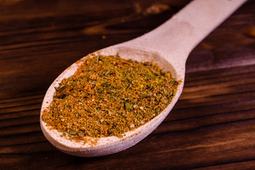 Mix of different seasonings in wooden spoon