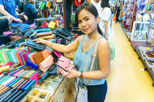 Beautiful asian young woman traveling and shopping at Chatuchak weekend market, Bangkok, Thailand