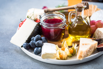 Cheese board with cranberry and autumn fruits