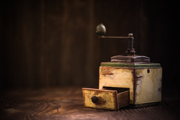 Toned image of vintage coffee grinder with roasted beans