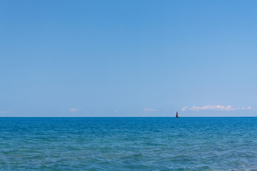 Fototapeta na wymiar Charming sea view of the calm sea under a blue sky