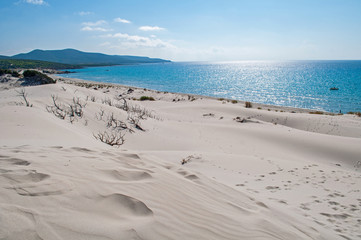 Blue sky, clear sea and sand dunes on the island of Sardinia
