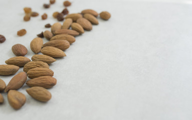 dried almonds on left side white grey background. Close-up