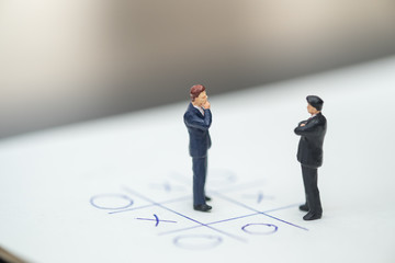 Business direction and planning concept. Two businessman miniature figure standing, face to face...