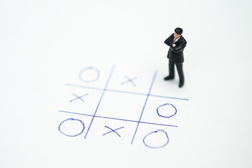 Business direction and planning concept. Businessman miniature figure standing and thinking on...