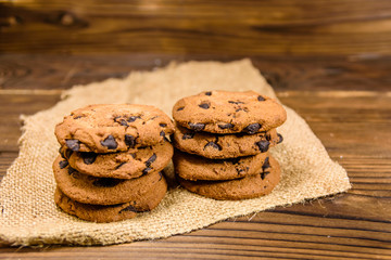 Chocolate chip cookies on sackcloth on a wooden table