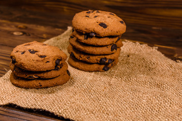 Chocolate chip cookies on sackcloth on a wooden table