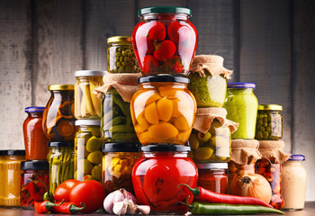 Jars with variety of pickled vegetables.