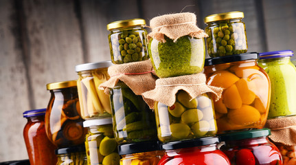 Jars with variety of pickled vegetables.