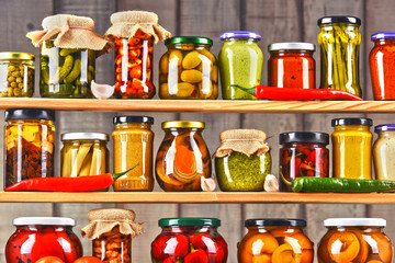Jars with variety of pickled vegetables.