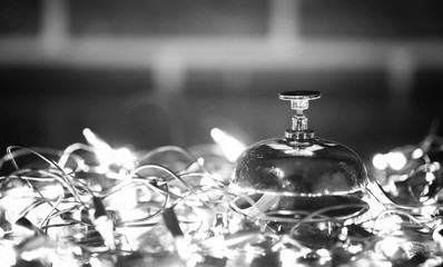 reception bell on the table and shining garland background