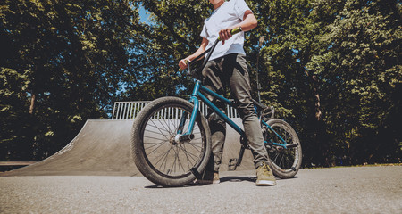 Bmx rider performing tricks at skatepark.