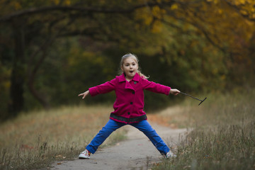 Little girl blocking hiking trail in forest