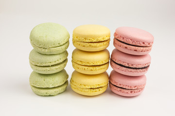 pile of french sweet macarons  in pink, yellow and green