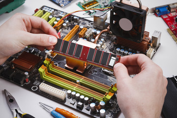 Technician plug in microprocessor to motherboard
