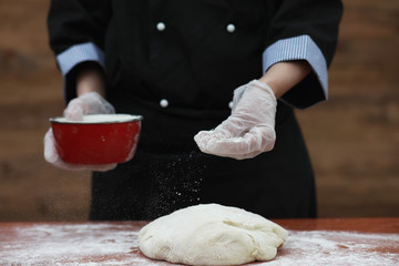 the cook makes flour for baking on the table