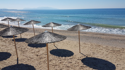 sea umbrellas shadows autum  in Preveza Greece