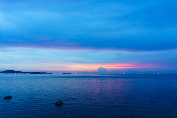 Fototapeta na wymiar beautiful panorama landscape of sea and sky at dusk in evening when sunset with multicolor light with mountain, blue sky and cloud background. sky and sea twilight.