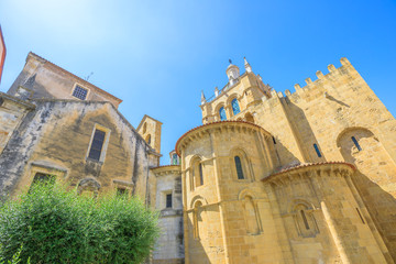 Behind the Old Coimbra Cathedral in a sunny day. Se Velha de Coimbra, is one of most important romanesque buildings in Portugal and landmark in university center town of Coimbra, north of Portugal.