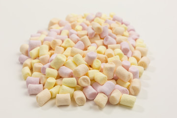 heap of tiny marshmallows in yellow, orange and pink