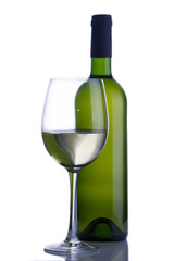 High glass with still white wine and green wine bottle isolated on white background