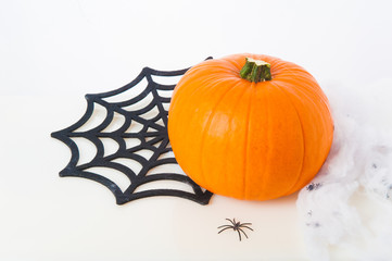 Halloween - pumpkin, spiders, cobweb,, on a light background.