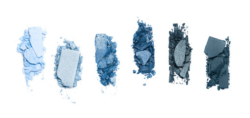 A smashed, blue toned eyeshadow make up palette isolated on a white background - obrazy, fototapety, plakaty