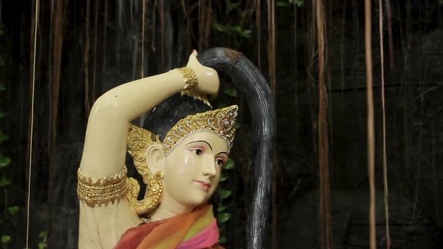 Sculpture in bushes. Golden mount (Wat Saket) Bangkok Thailand.