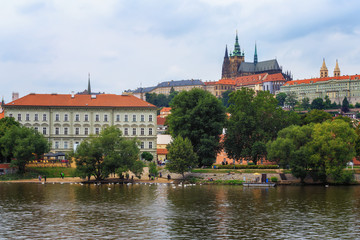 Fototapeta na wymiar The view of Prague castle from the other bank of the Vltava river.