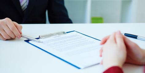 Closeup of businessman explaining  his new business partner the terms of the agreement or contract....