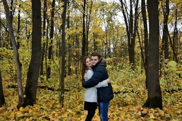 young loving couple in the autumn forest