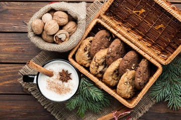 Fototapeta premium eggnog cocktail in mug arranged with christmas decoration and cookies box on wooden table