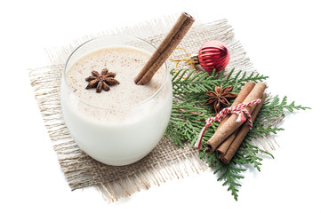 eggnog cocktail in glass arranged with christmas decoration isolated on white background
