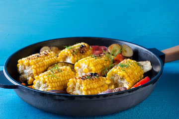 Corn and vegetables baked in frying pan