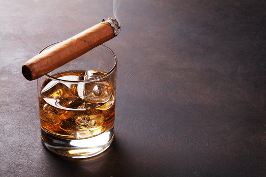 Whiskey with ice and cigar