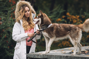 Woman with her dog in park at autumn