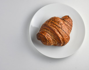 Overhead view of Chocolate drizzled onto croissant 
