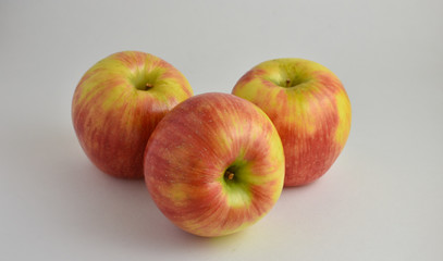 Three crisp and colorful Gala Apples on white background