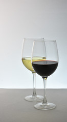 Two glasses of wine red wine in front of white