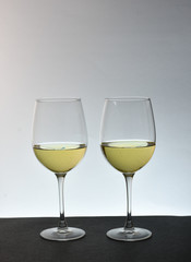 An isolated couple glasses of white wine with white background