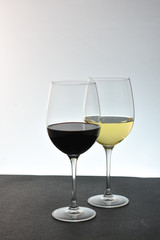 Two glasses of wine red  in front of white