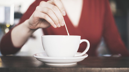 Barista drawing on coffee with a wooden stick. Coffee shop concept. Close up shot.
