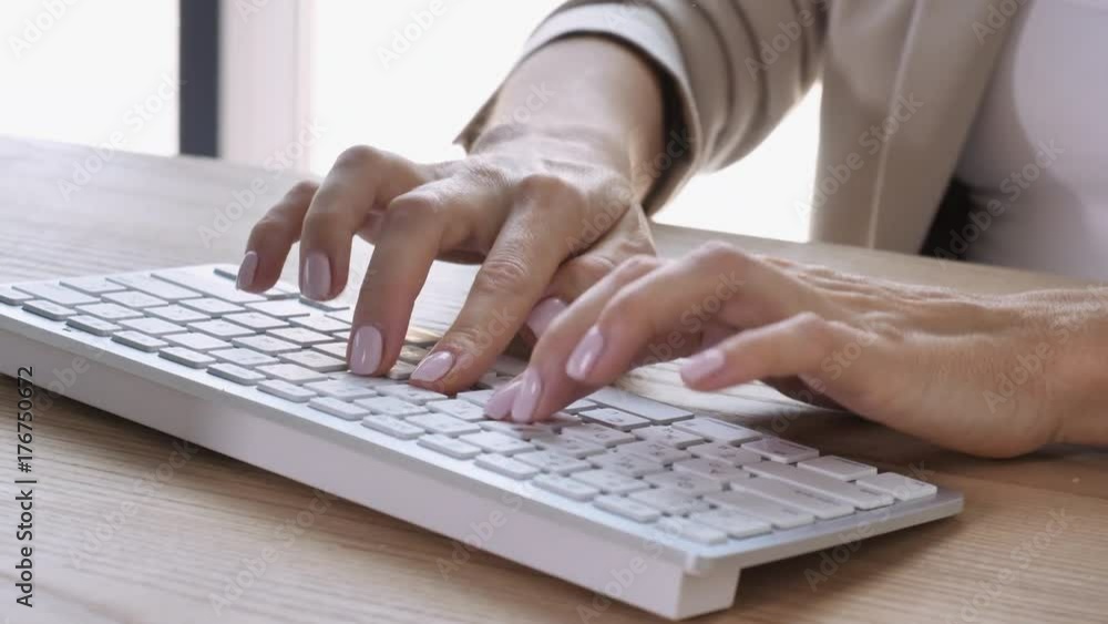 Poster close up details woman with elegant manicure typing on keyboard computer. female fingers fast enteri