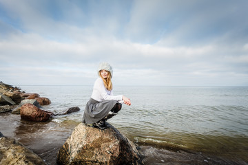 Woman on stones near sea