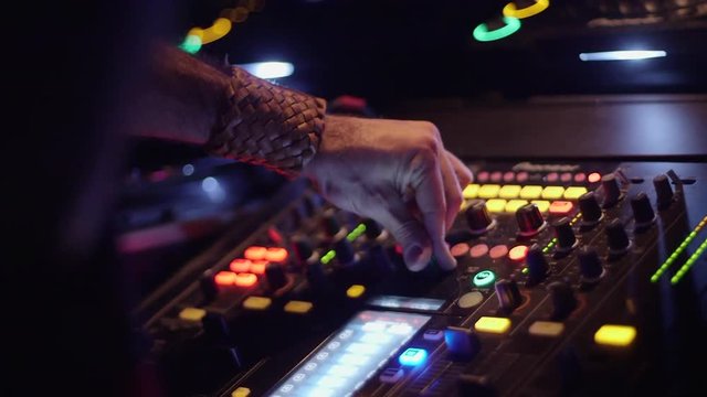 DJ hand close up turning knobs
