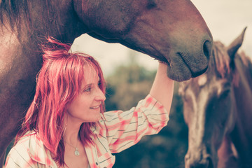 Western animal lover woman hugging horse