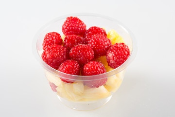 Fruit salad in take away cup on white background