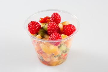 glass of fruit salad on white background